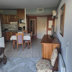 a kitchen and dining room with a table and chairs at Heliotel Marine plages piscines tennis terrasse jardin in Saint-Laurent-du-Var