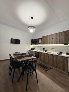 a kitchen with a table and chairs and a sink at MP House Kassandrino Halkidiki in Kassandrinón