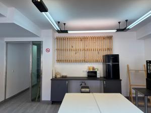 a room with a kitchen with a table and a microwave at Albergue el cristo in Porriño