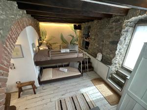 a bedroom with a bed in a room with a window at Madüneta 5 Terre in Corniglia