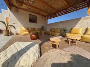 a living room with a couch and a table at Manapany Surf Camp in Tamraght Ouzdar