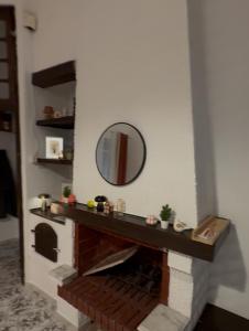 a fake fireplace with a mirror on a wall at Maison Mira in Bizerte