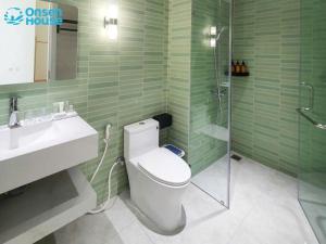 a bathroom with a toilet and a sink and a shower at OnsenHouse Boutique Stay - Căn hộ gần biển Mỹ Khê in Danang +36 photos