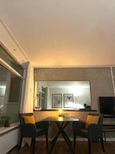 a living room with a table and chairs and a mirror at Traumblick auf‘s Meer in Sierksdorf