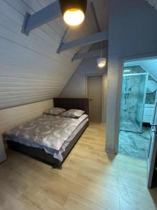 a bedroom with a bed and a glass door at Вича апартаменти in Sasivka