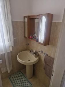 a bathroom with a sink and a mirror at Brezza Marina in Bova Marina +10 photos