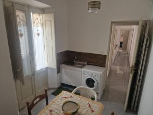 a kitchen with a washing machine and a sink at Brezza Marina in Bova Marina