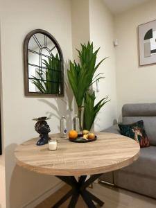a table with fruit on it in a living room at Bianca Suites II in Bormujos