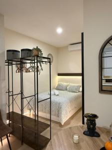 a bedroom with a bed and a black shelf at Bianca Suites II in Bormujos