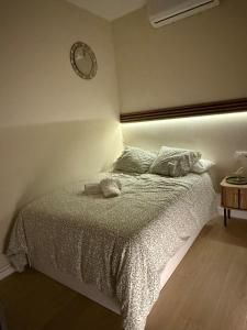 a bedroom with a bed with a clock on the wall at Bianca Suites II in Bormujos