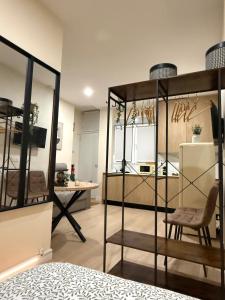 a room with a bed and a table and a kitchen at Bianca Suites II in Bormujos +5 photos