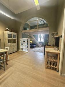 a large room with a loft bed and wooden floors at Aria di Mare - Tra Centro e Porto in Livorno
