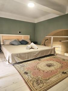 a bedroom with a large bed with a rug on the floor at Aria di Mare - Tra Centro e Porto in Livorno
