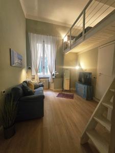 a living room with a couch and a loft at Aria di Mare - Tra Centro e Porto in Livorno