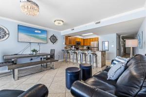 a living room with a couch and a piano at Pelican Beach Resort 504 in Destin