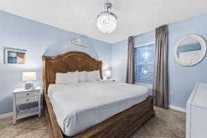 a bedroom with a bed and a window at Pelican Beach Resort 504 in Destin