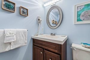 a bathroom with a sink and a mirror at Pelican Beach Resort 504 in Destin +25 photos