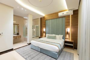 a bedroom with a large bed and a bathroom at Topaz Serviced Apartments in Riyadh +41 photos