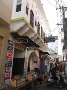 a building with a scooter parked in front of it at Shree Savitri Palace in Pushkar