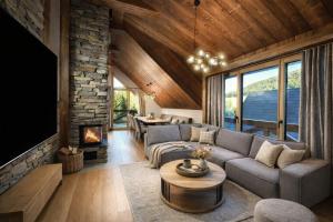 a living room with a couch and a fireplace at Chalet Oasis at Chalets Kvačianska dolina in Zuberec