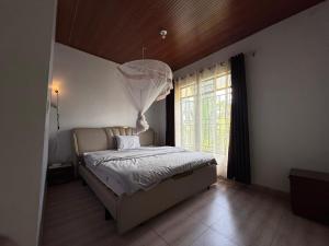 a bedroom with a bed with a chandelier above it at Eden house in Kigali