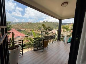 a balcony with a view of the mountains at Eden house in Kigali