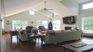 a living room with couches and a fireplace at Bay Breeze in Town Bank