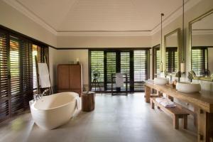 a bathroom with a tub, sink, and bathtub in it at Cape Weligama in Weligama