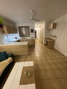 a large kitchen with a couch and a table at Between Caribean Seas in Cul de Sac +5 photos