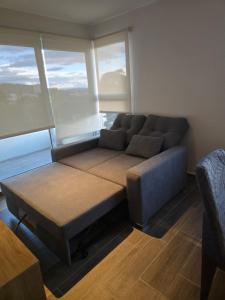 a large couch in a room with windows at Apartamento La Villa del Castillo in El Rodeo +13 photos