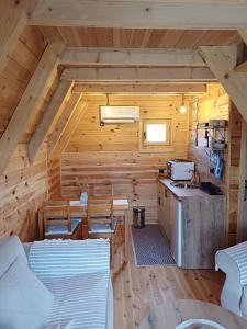 a log cabin with a kitchen and a stove at Diva House in Nikšić