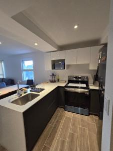 a kitchen with a sink and a stove top oven at Apartamento La Villa del Castillo in El Rodeo