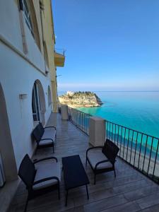 a balcony with chairs and a view of the ocean at Seaside Soul in Tropea