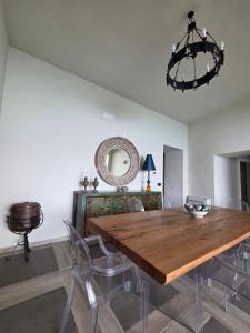 a dining room with a wooden table and chairs at Seaside Soul in Tropea