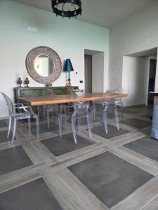 a dining room with a table and chairs and a mirror at Seaside Soul in Tropea +17 photos