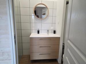 a bathroom with a sink and a mirror at Maisonnette privative Bassin Arcachon in Le Teich +10 photos