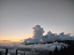 a group of clouds in the sky at sunset at Hotel Crown Palace in Dunga Gali