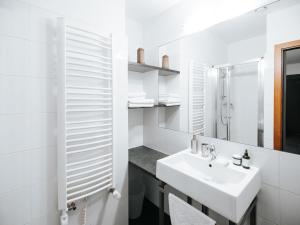 a white bathroom with a sink and a mirror at Pensjonat Maria 2 in Szczyrk +54 photos