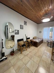 a living room with a couch and a mirror at Las Heras Apart in Eldorado
