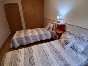 a room with two beds and a lamp on a table at Ayalga2 in Villaviciosa