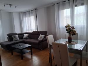 a living room with a couch and a table at Ayalga2 in Villaviciosa +15 photos