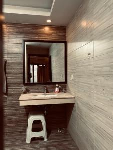 a bathroom with a sink and a mirror at SmartStay Residences in Rawalpindi