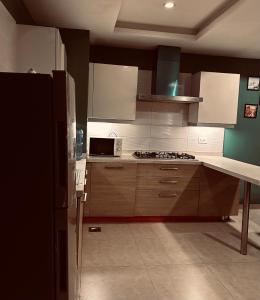 a kitchen with a refrigerator and a stove top oven at SmartStay Residences in Rawalpindi +3 photos