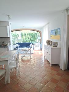 a kitchen and living room with a tile floor at Daphne Experience - Home, Harmony and Garden in Loreto Aprutino
