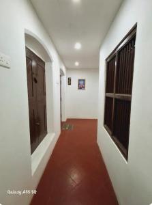 a hallway of a house with a door at Umbrella Guest House - Meenakshi Suite in Madurai +6 photos