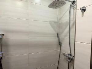 a shower with a glass door in a bathroom at Bungalow Marita in Julianadorp