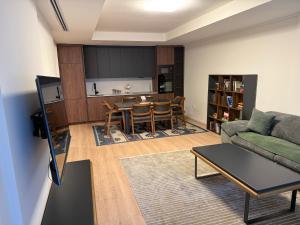 a living room with a couch and a table at OMA Residence in Ferizaj