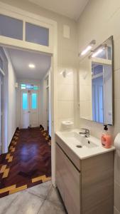 a bathroom with a sink and a mirror and a hallway at Casa Palmeiras, Seixal , Madeira in Seixal +50 photos