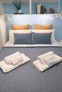 a bed with two white towels and pillows on it at Casa aMare in Chioggia