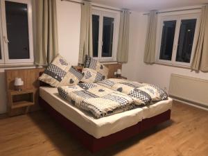 a bedroom with a bed with pillows on it at Gästehaus AlbTraum in Reutti
